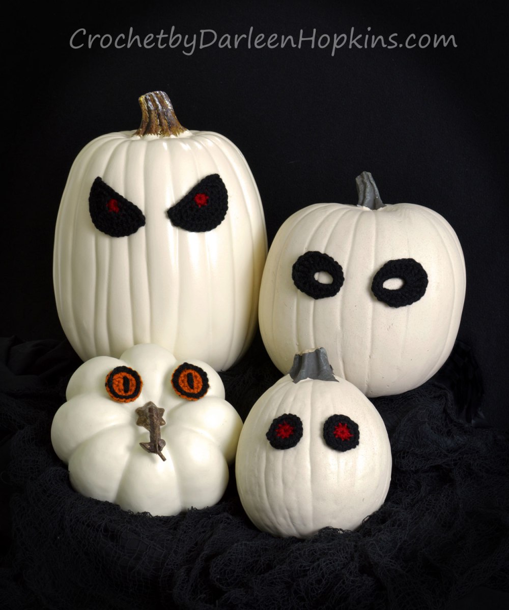 Ghost pumpkins with crocheted eyes. Pattern by Darleen Hopkins