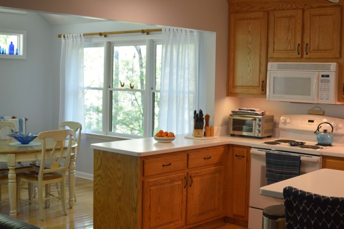 Oak-wood-cabinets-white-countertop-blue-walls-oiled-bronze-fixtures-hardware-kitchen-oak-floors-4
